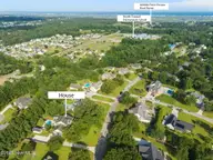 107 Wild Berry Lane, Hampstead, NC 28443 — 4-bedroom waterfront home in Bent Tree, Hampstead, NC, photo 2 of 78: 82-web-or-mls-DJI_20250710173952_0676_D_