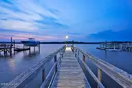 6008 W Beach Drive, Oak Island, NC 28465 — 6-bedroom waterfront home, Oak Island, NC, photo 13 of 75: 6008WestBeachDrive_twilight-6