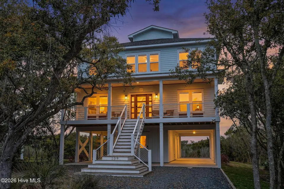 109 Old Village Lane, North Topsail Beach, NC 28460 — 8-bedroom waterfront home in The Village of Stump Sound, North Topsail Beach, NC, photo 1 of 73: 109OldVillage_Front_01_Dusk_02