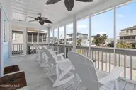 430 3rd Street, Sunset Beach, NC 28468 — 3-bedroom home, Sunset Beach, NC, photo 12 of 48: Shady area on this screened front porch