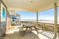 1819 Salter Path Road, Indian Beach, NC 28512 — 5-bedroom waterfront home in Roosevelt Estate, Indian Beach, NC, photo 13 of 58: Open & covered porch overlooks beach