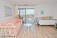 9100 Reed Drive 3202, Emerald Isle, NC 28594 — 1-bedroom waterfront condo in Queens Court, Emerald Isle, NC, photo 4 of 52: Daybed and sleeper sofa in Greatroom