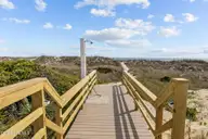 233 Sea Dreams Drive, Atlantic Beach, NC 28512 — 3-bedroom home in Sea Dreams, Atlantic Beach, NC, photo 16 of 68: beachwalkway via pool and shower