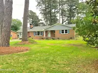 1018 Karen Drive, New Bern, NC 28562 — 3-bedroom home in Kingswood Villas, New Bern, NC, photo 24 of 24: 1018 Karen Front of house magnolia tree