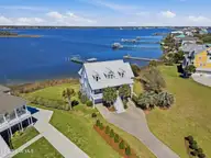 5 Osprey Circle, North Topsail Beach, NC 28460 — 3-bedroom waterfront home in Crystal Shores, North Topsail Beach, NC, photo 4 of 79: 6_front left aerial