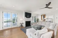 585 Forest Dunes Drive, Pine Knoll Shores, NC 28512 — 4-bedroom waterfront home in Beacon's Reach, Pine Knoll Shores, NC, photo 8 of 68: First floor living w wet bar & fireplace