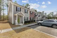 155 Lincoln Place Circle, Leland, NC 28451 — 3-bedroom townhome in Lincoln Place Townhomes, Leland, NC, photo 2 of 39: 155 Lincoln Place CIrcle - Brick front
