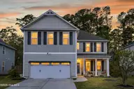 9397 Cassadine Court, Leland, NC 28451 — 3-bedroom home in Windermere Estates, Leland, NC, photo 2 of 42: 9397Cassadine_Front_Dusk_02