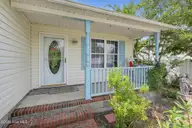 121 NE 6th Street, Oak Island, NC 28465 — 3-bedroom home in Tranquil Harbor, Oak Island, NC, photo 3 of 21: 08_121_NE_6th_St-Exterior-GE10