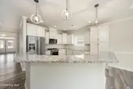 8983 Mango Bay Court NE, Leland, NC 28451 — 4-bedroom townhome in Compass Pointe, Leland, NC, photo 16 of 53: High Bar Seating