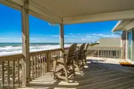 1819 Salter Path Road, Indian Beach, NC 28512 — 5-bedroom waterfront home in Roosevelt Estate, Indian Beach, NC, photo 14 of 58: Open & covered porch overlooks beach