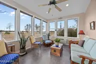 204 Tupelo Lane, Washington, NC 27889 — 3-bedroom waterfront home in Pamlico Plantation, Washington, NC, photo 17 of 44: Sunroom