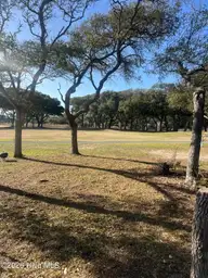 44 Pinehurst Drive, Oak Island, NC 28465 — 2-bedroom home in Caswell Dunes, Oak Island, NC, photo 3 of 14: Backyard View
