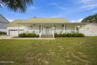 321 NE 60th Street, Oak Island, NC 28465 — 3-bedroom home in Tranquil Harbor, Oak Island, NC, photo 1 of 42