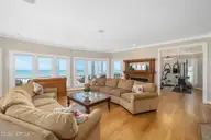 3107 Ocean Drive, Emerald Isle, NC 28594 — 6-bedroom waterfront home in Emerald Isle By The Sea, Emerald Isle, NC, photo 4 of 59: Open living room w/ fireplace