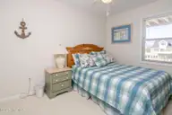 1131 S Shore Drive, Surf City, NC 28445 — 4-bedroom waterfront home in Horse Hammock, Surf City, NC, photo 14 of 40: Poolside South Queen Bedroom