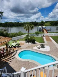 1404 W Yacht Drive, Oak Island, NC 28465 — 3-bedroom waterfront home in Pinners Point, Oak Island, NC, photo 20 of 46: outdoor summertime