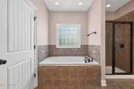 53 Westcliff Court, Clayton, NC 27527 — 5-bedroom home in The Knolls at the Neuse, Clayton, NC, photo 14 of 33: Separate soaking tub and tiled shower