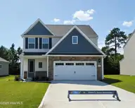 200 S Umbrella Palm Drive, Hampstead, NC 28443 — 4-bedroom home in Southwater Village, Hampstead, NC, photo 1 of 2: 200 Umbrella Palm