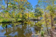 2807 Cross Bones Road SW, Supply, NC 28462 — 3-bedroom waterfront manufactured home in Buccaneer Hills, Supply, NC, photo 24 of 31: Pond Front