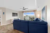 212 Old Causeway Road 107 & B13 Slip, Beaufort, NC 28516 — 3-bedroom waterfront condo in Morgan Creek Landing, Beaufort, NC, photo 4 of 49: Living room with covered balcony access