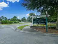 1141 Greensview Circle, Leland, NC 28451 — 2-bedroom townhome in Magnolia Greens, Leland, NC, photo 20 of 30: Mag Green Sign
