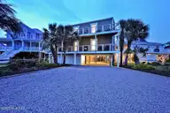 6008 W Beach Drive, Oak Island, NC 28465 — 6-bedroom waterfront home, Oak Island, NC, photo 2 of 75: 6008WestBeachDrive_twilight-1