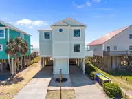 2205 E Beach Drive, Oak Island, NC 28465 — 6-bedroom waterfront home in Long Beach, Oak Island, NC, photo 1 of 55