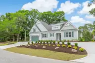 394 Sea Trail Drive W, Sunset Beach, NC 28468 — 4-bedroom home in Sea Trail Plantation, Sunset Beach, NC, photo 2 of 76: Front Elevation -Circular Drive