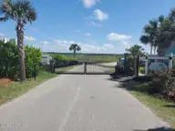 1534 94 Riverside Drive, Sunset Beach, NC 28468 — waterfront lot in Ocean Club Estates, Sunset Beach, NC, photo 4 of 44: OC Gate