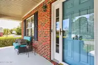 125 Lighthouse Drive, Carolina Beach, NC 28428 — 3-bedroom home in Carolina Beach Village, Carolina Beach, NC, photo 19 of 70: Covered Front Porch