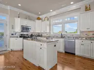 6414 Ocean Drive, Emerald Isle, NC 28594 — 5-bedroom waterfront home in Sea Crest, Emerald Isle, NC, photo 16 of 56: Kitchen opens to back deck