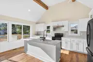 501 Shoreline Drive E, Sunset Beach, NC 28468 — 3-bedroom waterfront home in Shoreline Woods, Sunset Beach, NC, photo 7 of 39: Bright Kitchen