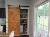 104 Falken Court, New Bern, NC 28562 — 4-bedroom home in Lindenrain, New Bern, NC, photo 9 of 33: pantry barn door