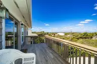 1819 Salter Path Road, Indian Beach, NC 28512 — 5-bedroom waterfront home in Roosevelt Estate, Indian Beach, NC, photo 23 of 58: Open deck off kitchen/dining space