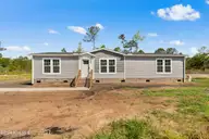 6830 Lewis Drive SE, Winnabow, NC 28479 — 3-bedroom manufactured home in Lewis Acres, Winnabow, NC, photo 1 of 29: 6830 Lewis Dr
