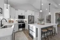 206 Stonewood Drive, Goldsboro, NC 27530 — 3-bedroom home in Stonewood Estates, Goldsboro, NC, photo 11 of 38: Modern farmhouse kitchen with rustic acc