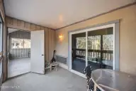 1306 Harbourside Drive, New Bern, NC 28560 — 2-bedroom waterfront condo in Fairfield Harbour, New Bern, NC, photo 17 of 36: Porch Connects To Downstairs Bedroom