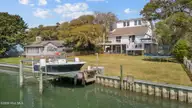 125 Loblolly Drive, Pine Knoll Shores, NC 28512 — 5-bedroom waterfront home in Pine Knoll Association, Pine Knoll Shores, NC, photo 1 of 68: Dock and home
