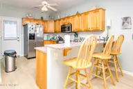 1131 S Shore Drive, Surf City, NC 28445 — 4-bedroom waterfront home in Horse Hammock, Surf City, NC, photo 3 of 40: Kitchen with Eat-In Seating