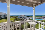 9201 Coast Guard Road A208, Emerald Isle, NC 28594 — 3-bedroom waterfront condo in Pebble Beach, Emerald Isle, NC, photo 3 of 45: Covered porch overlooking pool and ocean