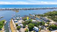 105 Teakwood Drive Apt 702, Carolina Beach, NC 28428 — 2-bedroom waterfront condo in Otter Creek, Carolina Beach, NC, photo 1 of 55: 56_dji_20260420120220_0459_d_1