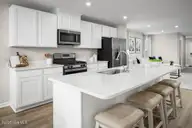 6007 Roundwood Drive NW, Ash, NC 28420 — 3-bedroom home in Sterling Oaks, Ash, NC, photo 12 of 15: Rosewood Kit