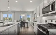 530 Glitter Bay Loop, Shallotte, NC 28470 — 3-bedroom home in Solserra, Shallotte, NC, photo 6 of 30: Kitchen to Cafe