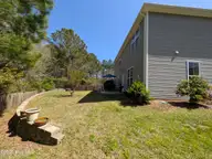 114 Lumis Court, Hampstead, NC 28443 — 4-bedroom home in Dogwood Lakes, Hampstead, NC, photo 23 of 26: Large wide yard