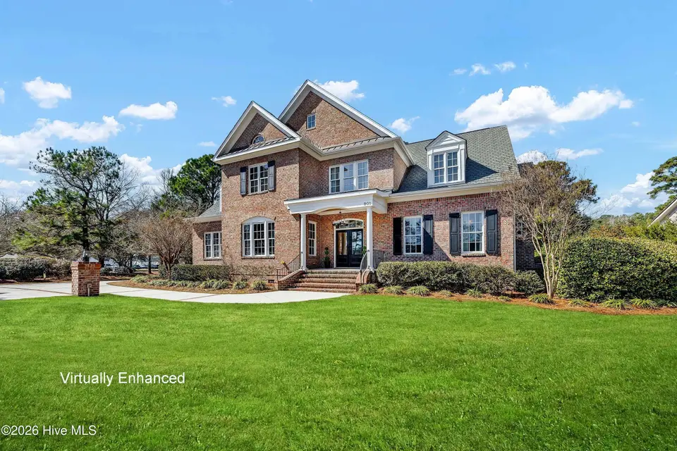 901 Sun Runner Place, Wilmington, NC 28405 — 4-bedroom home in Landfall, Wilmington, NC, photo 1 of 66: Front with green grass