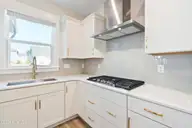 1368 Trisail Terrace, Wilmington, NC 28412 — 3-bedroom home in Riverlights, Wilmington, NC, photo 21 of 68: 1368 Trisail stove and hood vent