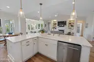 145 W Keel Drive, Hampstead, NC 28443 — 3-bedroom home in Salters Haven at Lea Marina, Hampstead, NC, photo 8 of 57: kitchen and living area