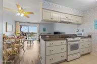 9100 Reed Drive 3202, Emerald Isle, NC 28594 — 1-bedroom waterfront condo in Queens Court, Emerald Isle, NC, photo 18 of 52: Kitchen to great room