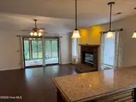 515 Fairway Drive W, Sunset Beach, NC 28468 — 3-bedroom home in Sea Trail Plantation, Sunset Beach, NC, photo 14 of 25: sun room living room from kitchen